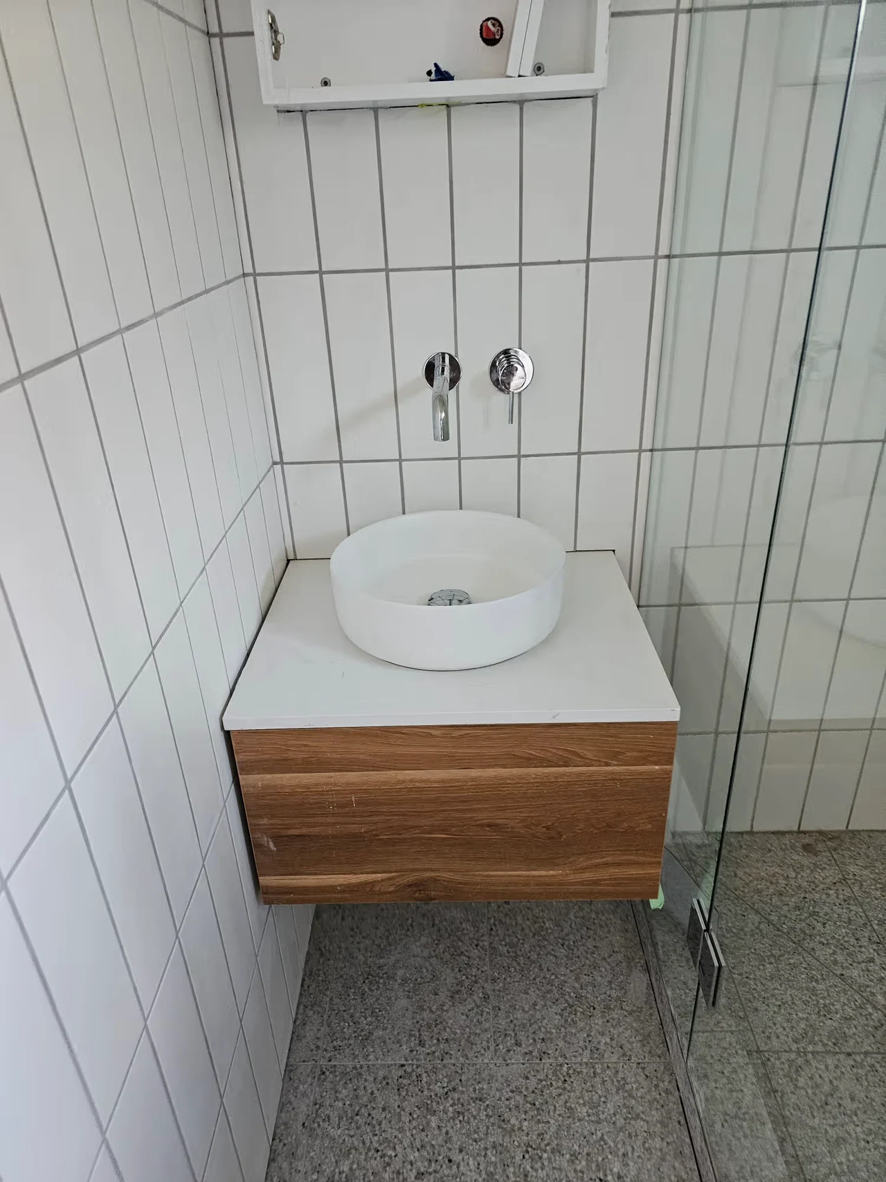 Round basin, wall-mounted tap and timber vanity on a Flow-Rite job